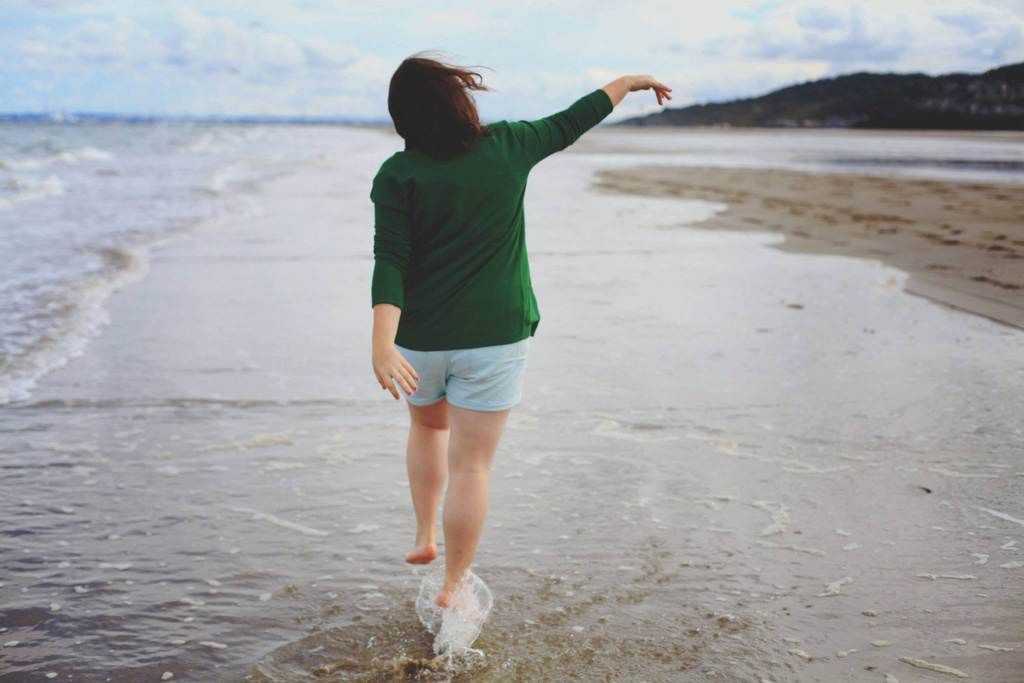 Person Walking on Beach